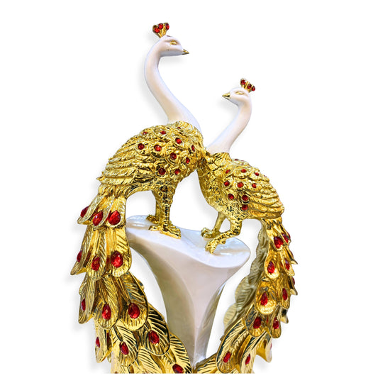 Close-up of handcrafted golden peacock feathers with red embellishments – detailed artistic polystone décor statue