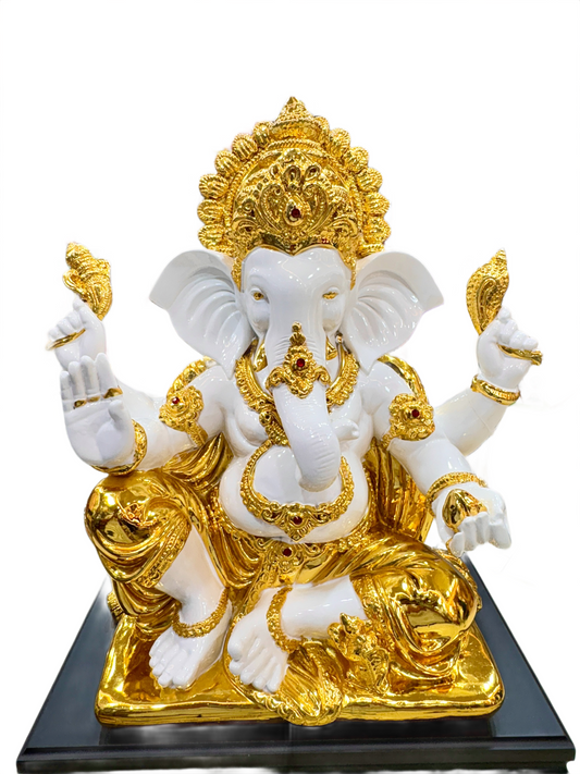 White and gold statue of a deity on a black base