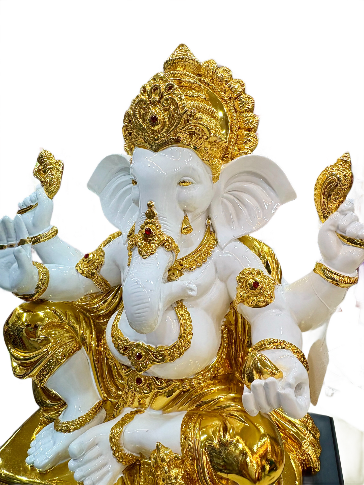 Decorative statue of a deity with gold and white colors on a white background