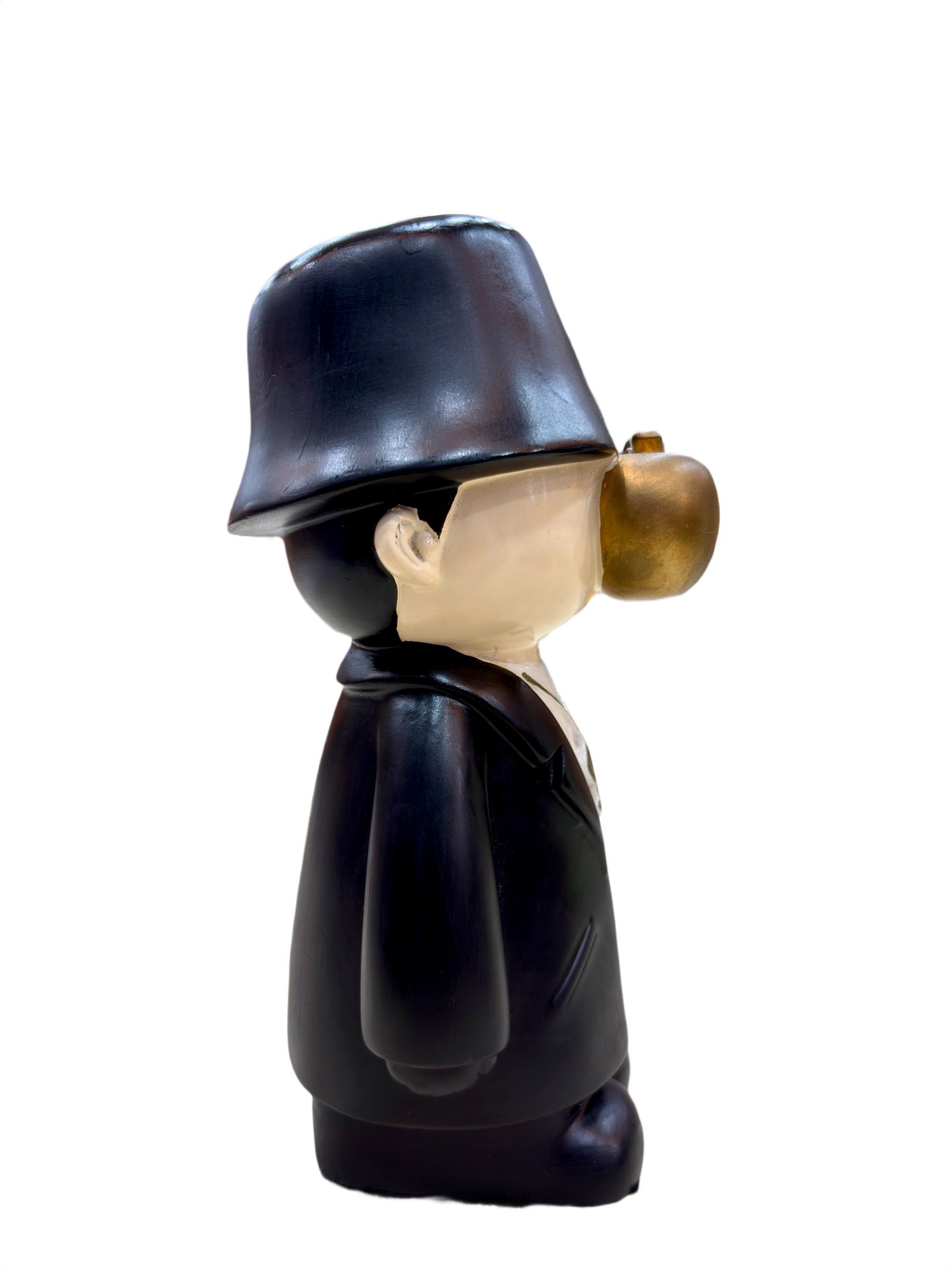 Left side view of 9.5 inch resin figurine with black coat, bucket hat, golden apple face and gold dollar chain, quirky home décor collectible