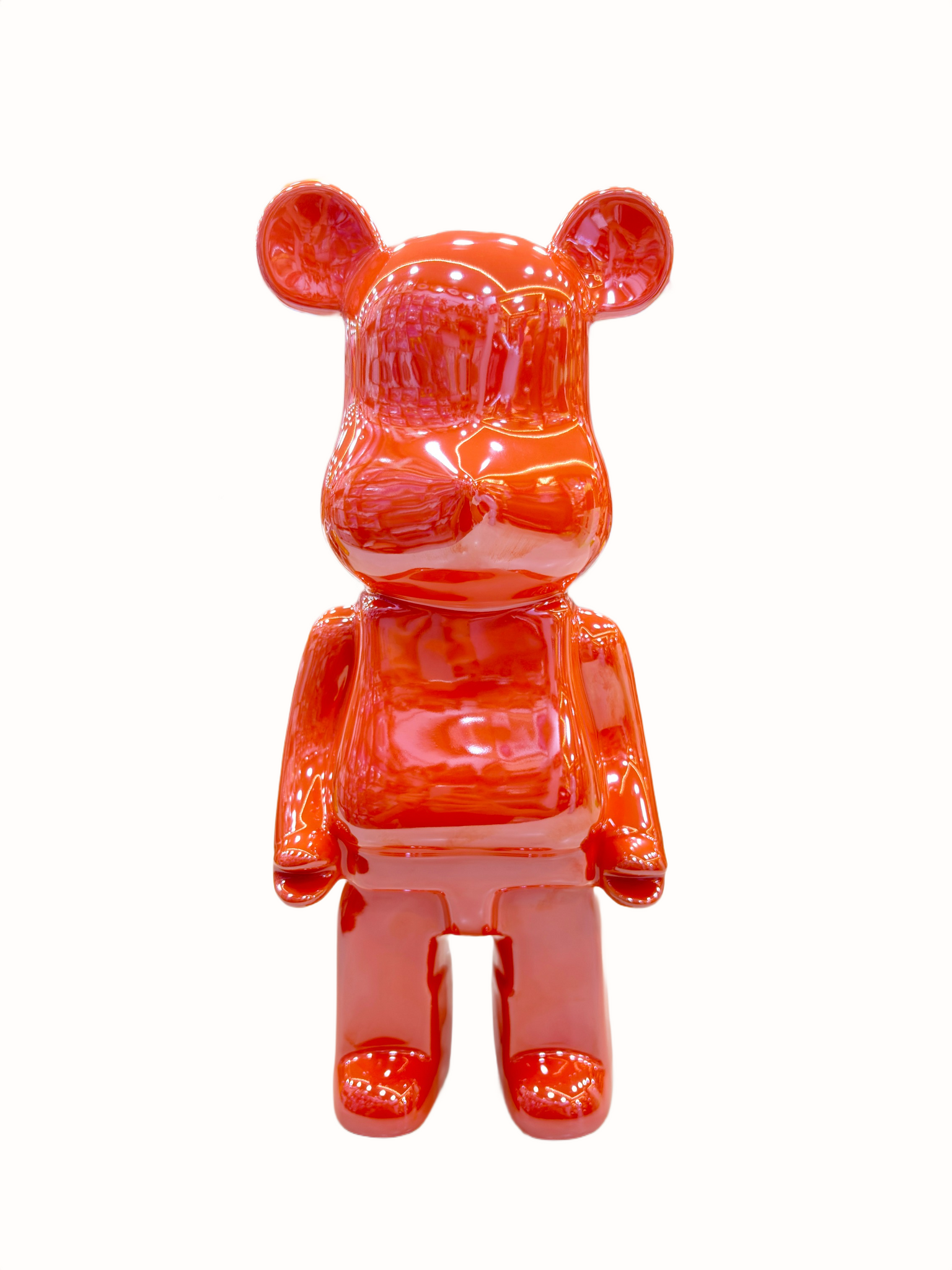 Glossy orange bear-like figure on a white background.