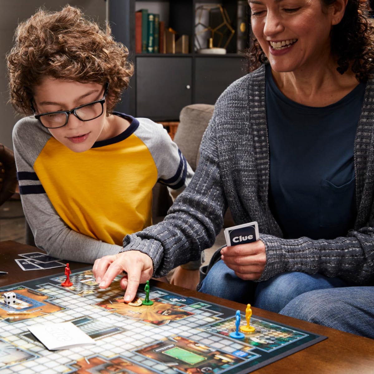 Family playing Hasbro Clue detective board game together