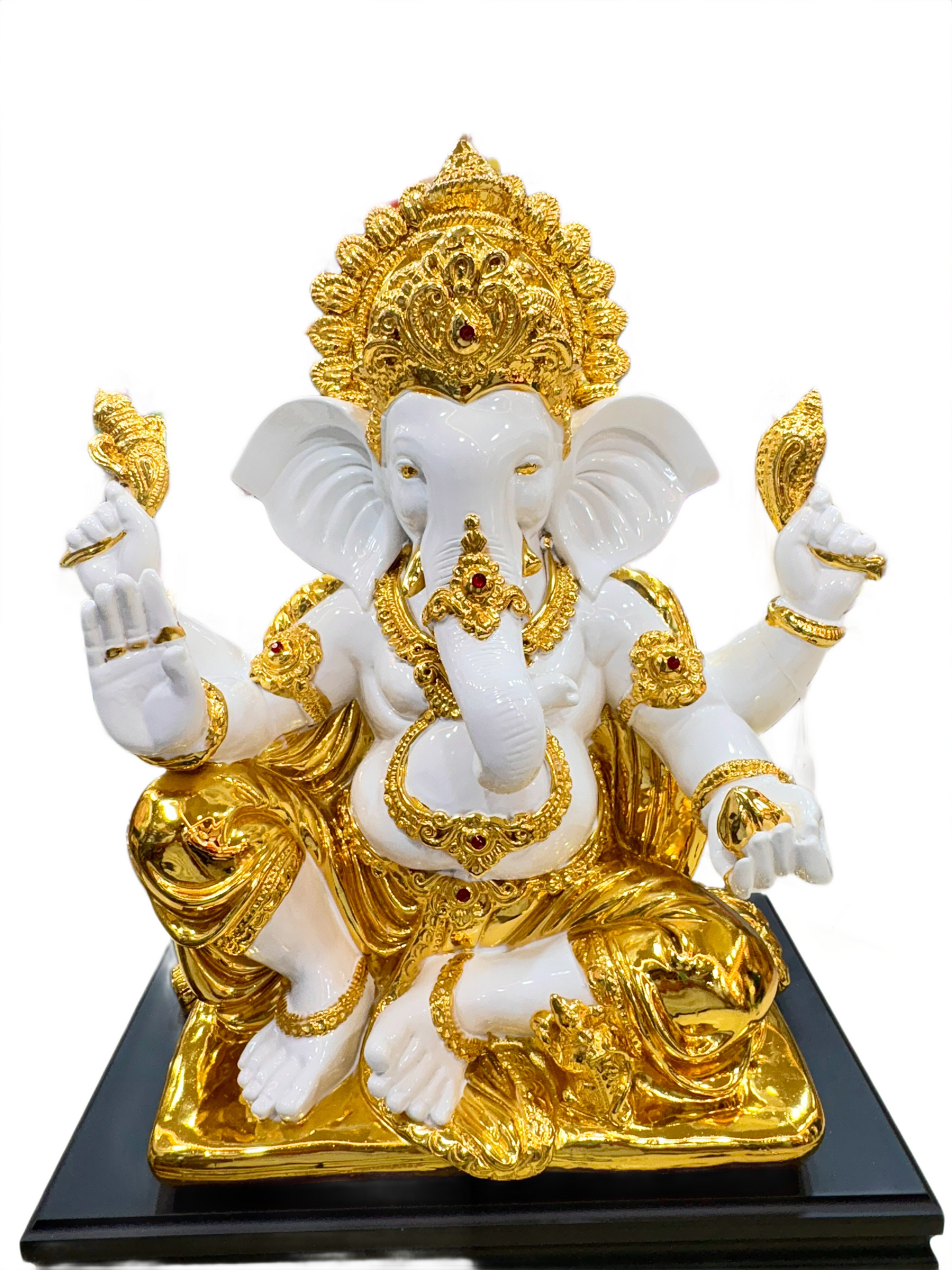 White and gold ganesha statue of a deity on a black base