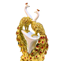 Close-up of handcrafted golden peacock feathers with red embellishments – detailed artistic polystone décor statue