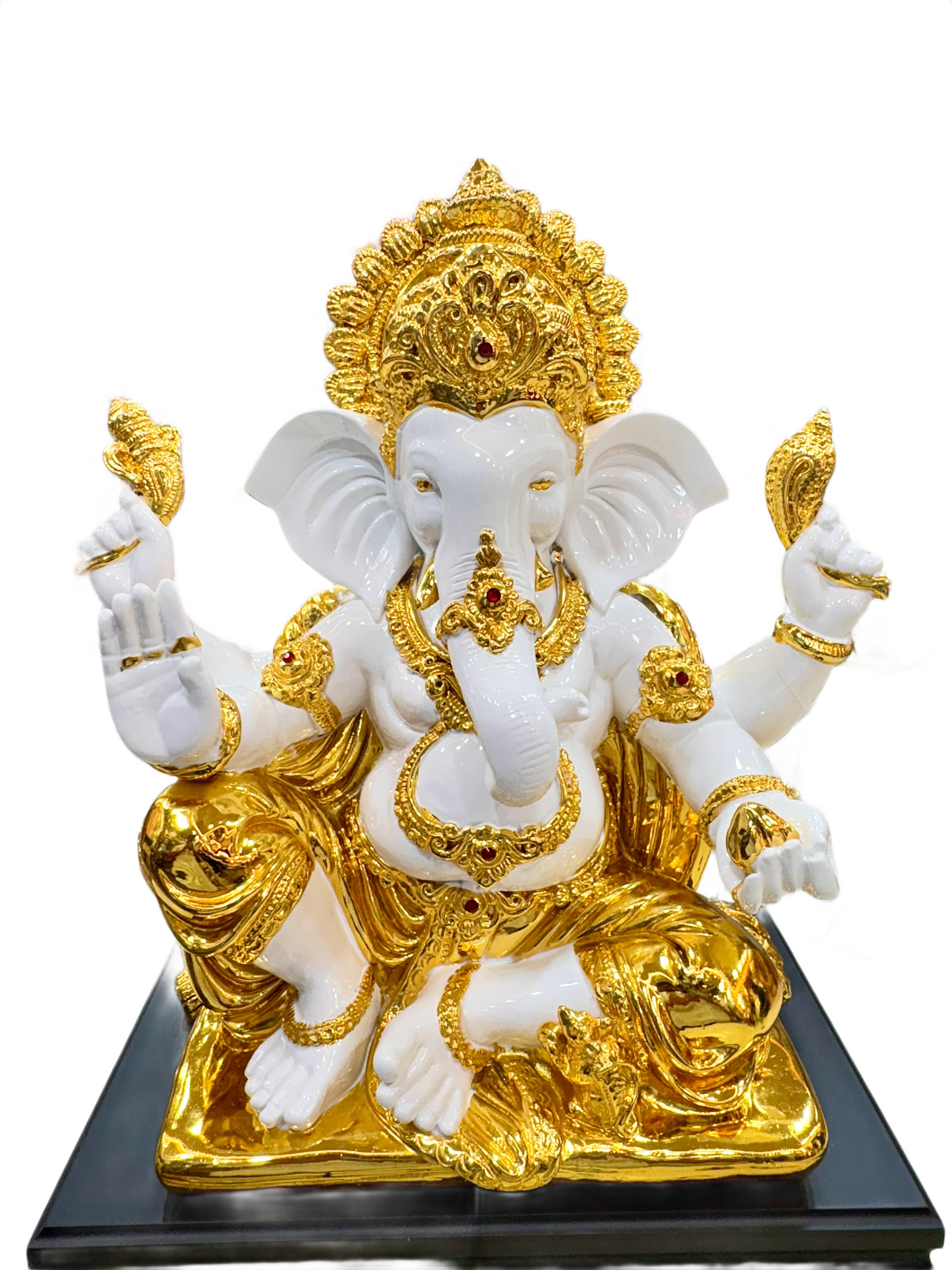 White and gold statue of a deity on a black base
