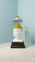 Buddha head sculpture with gold hair on a black base against a light blue wall.
