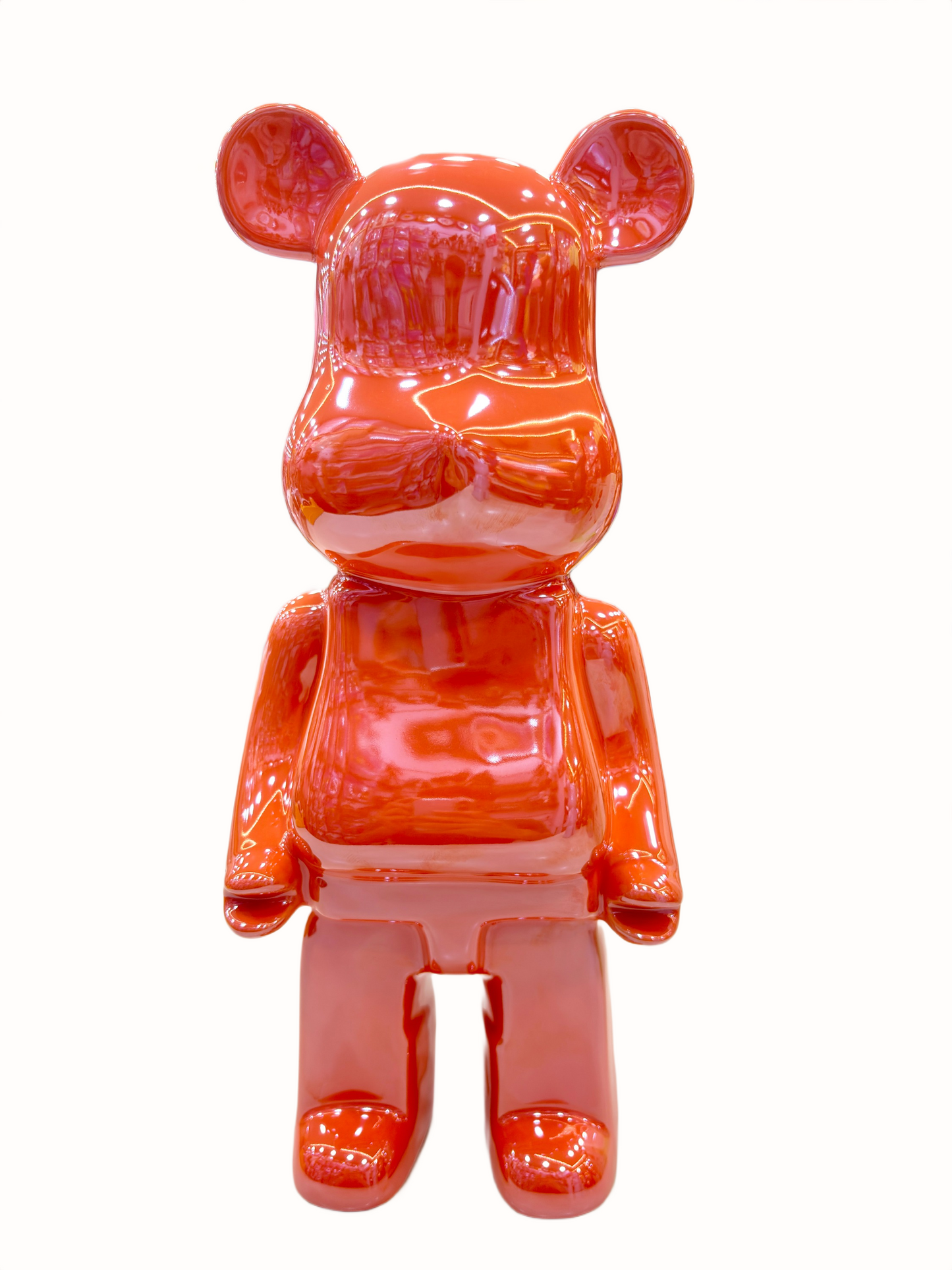 Glossy orange bear-like figure on a white background.
