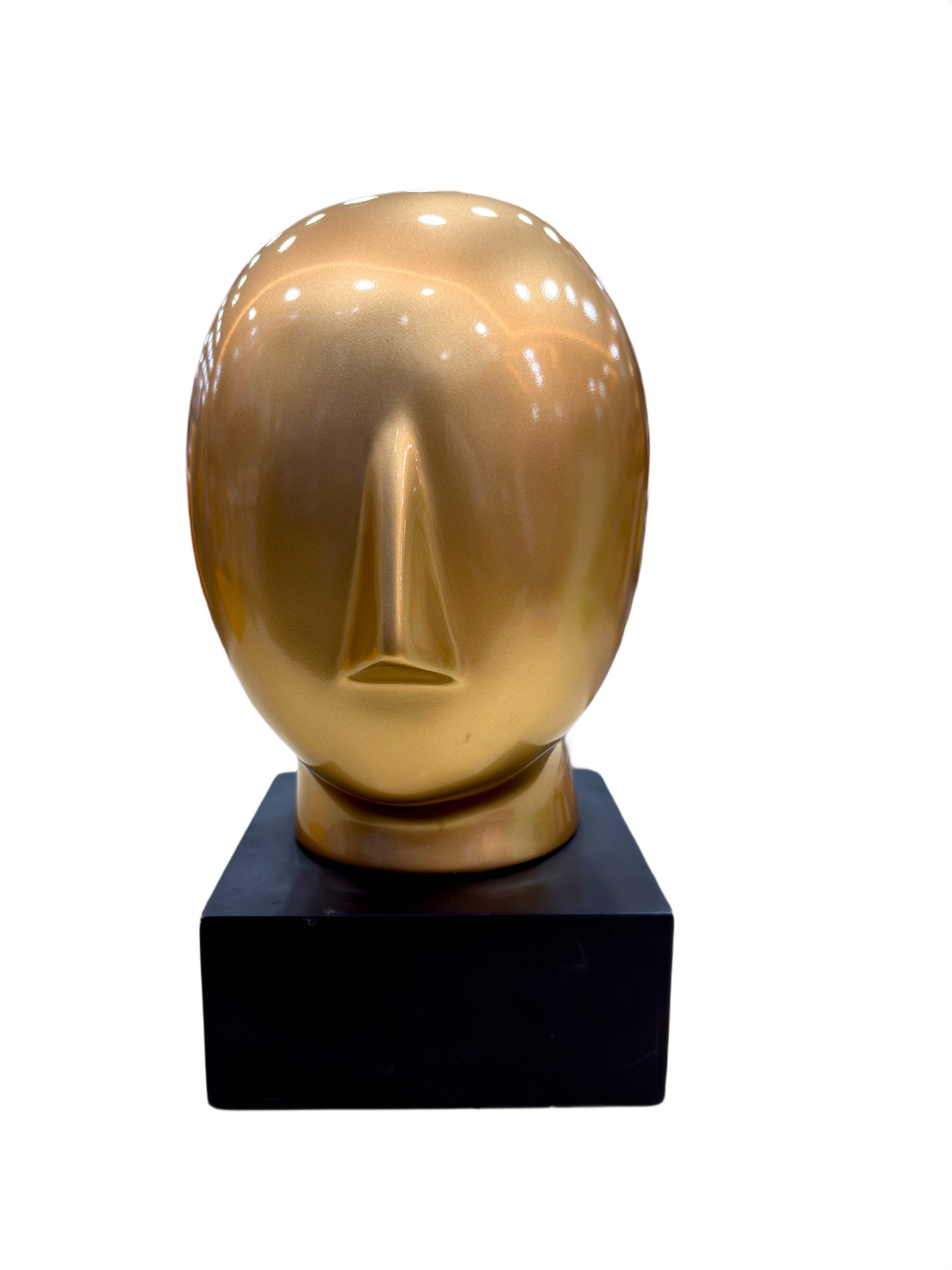 Close-up of Golden Abstract Face sculpture with modern abstract detailing