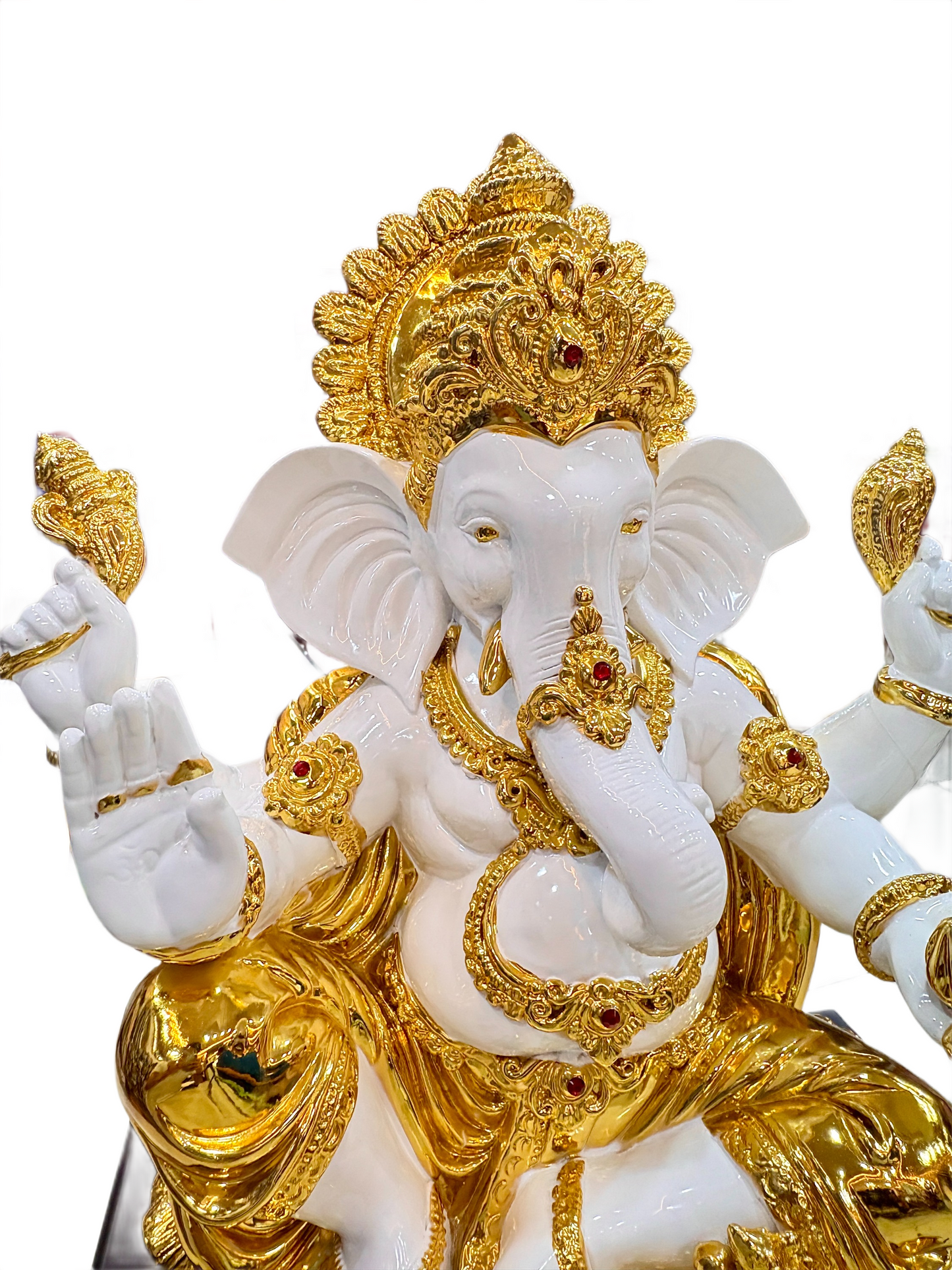 Decorative statue of a deity with gold and white details on a white background