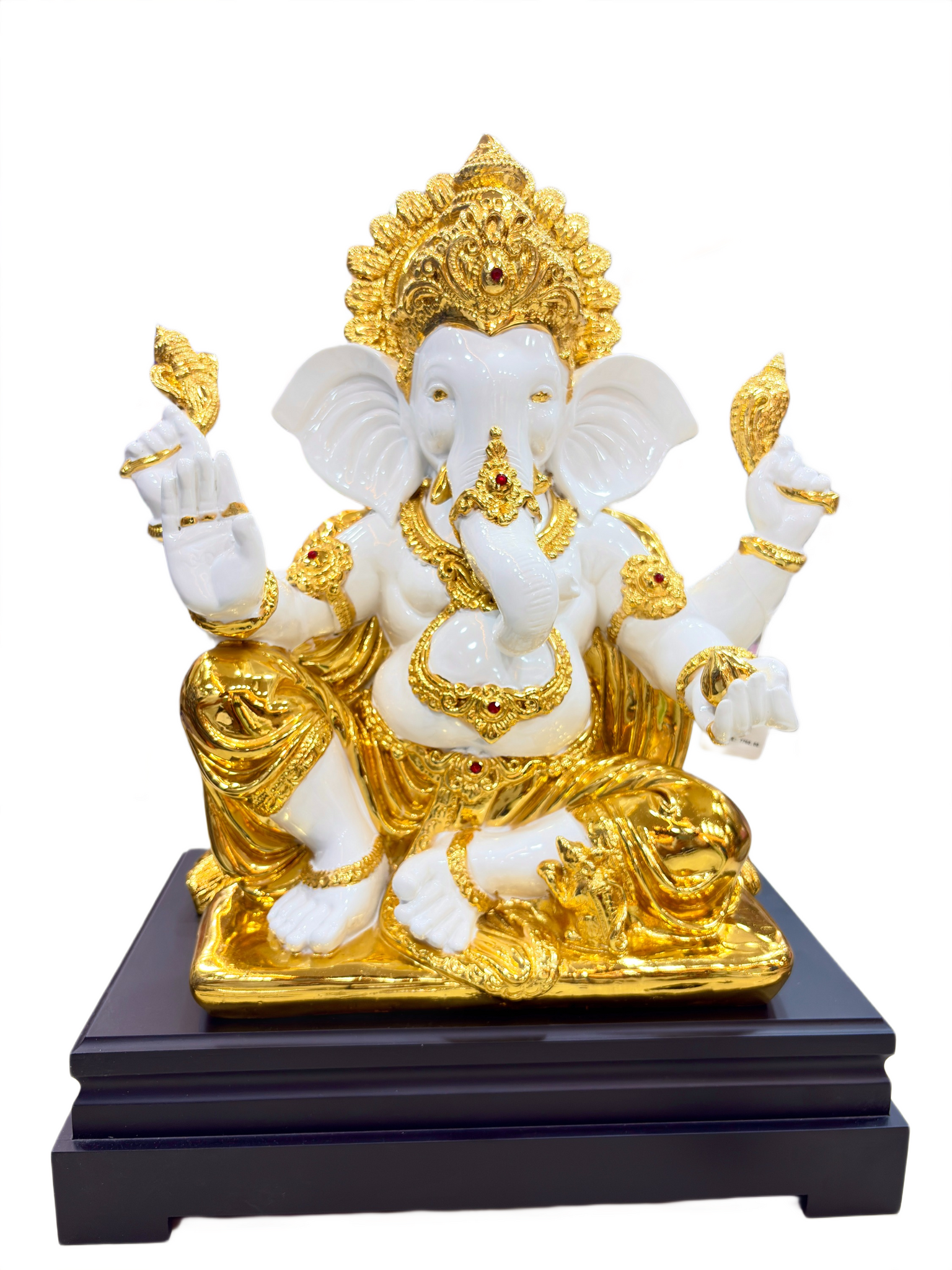Decorative statue of a deity with gold and white colors on a black base.