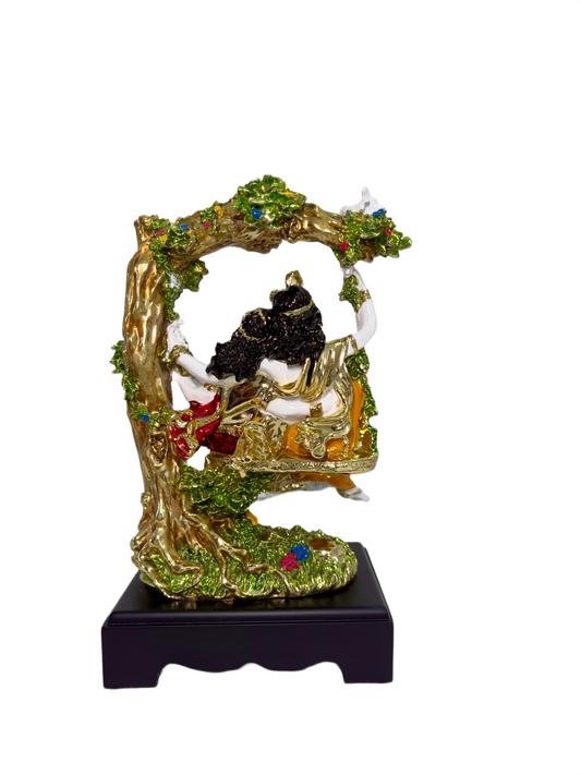 Close-up of Radha Krishna jhula idol with intricate golden accents and floral detailing
