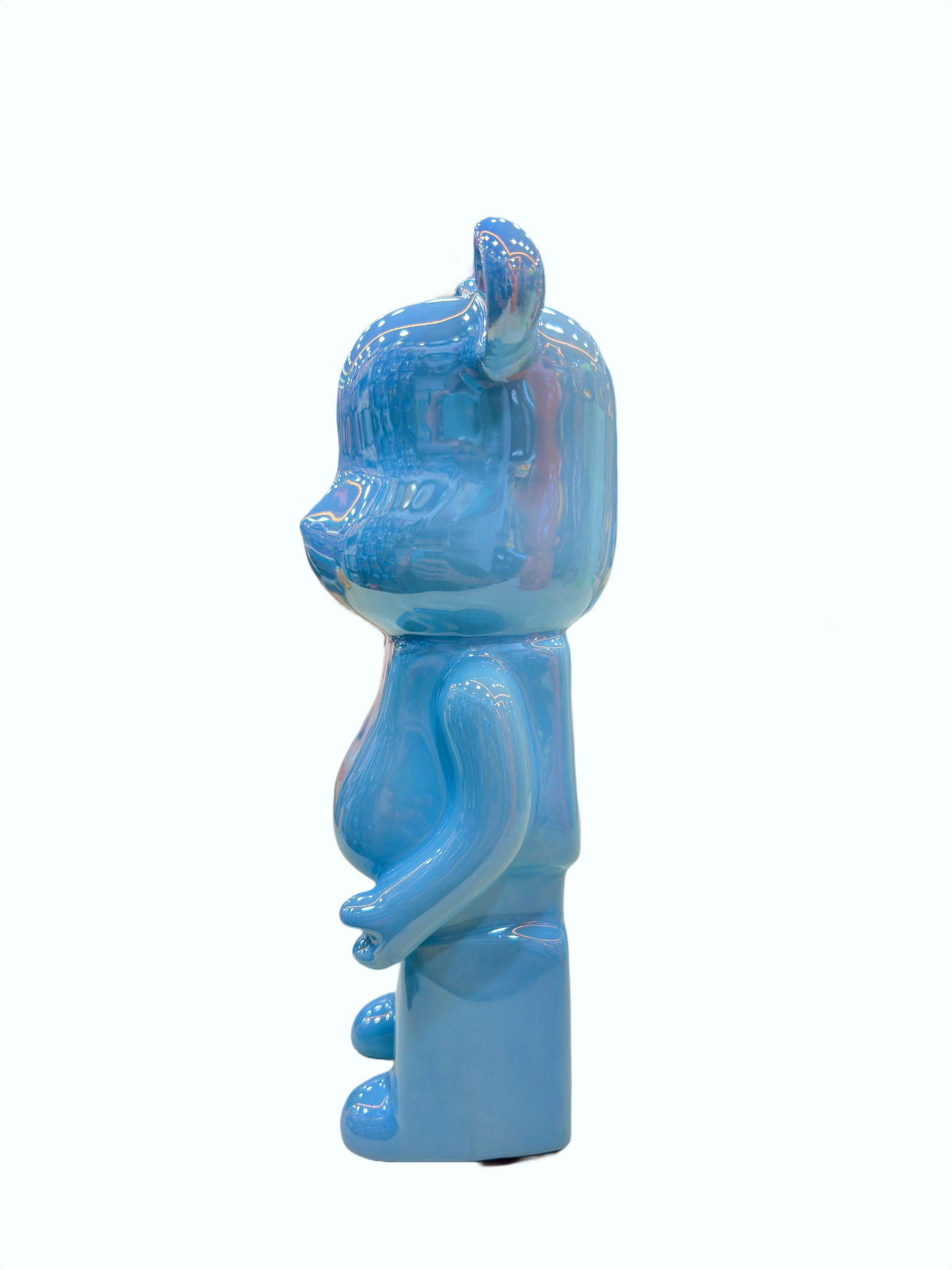 Side angle of glossy blue ceramic bear piggy bank showpiece for home décor.