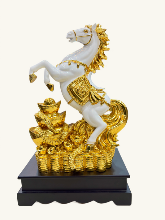 Decorative statue of a white horse with gold accents on a black base 